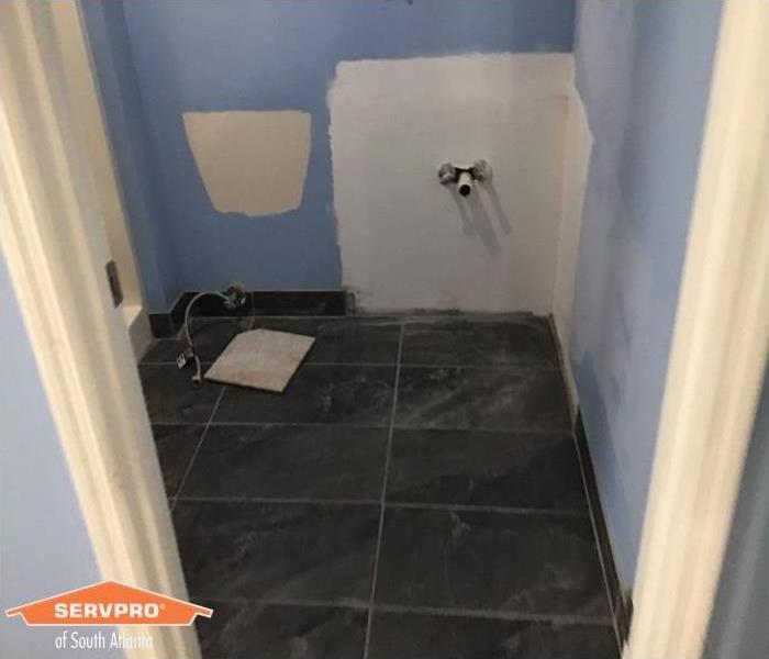 water damaged tile floor in bathroom