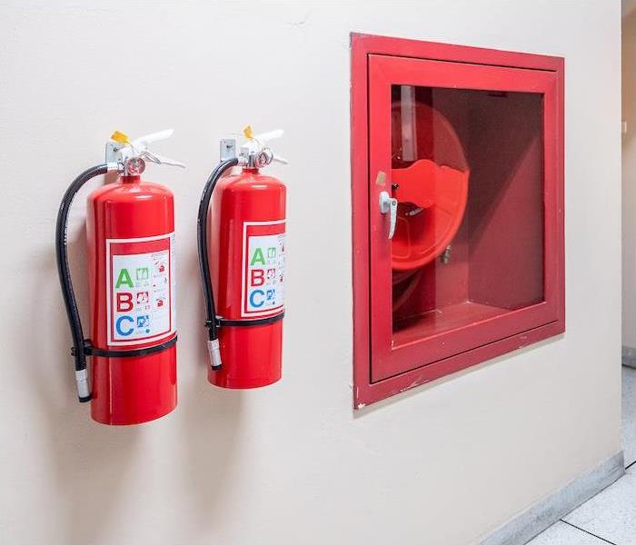 mg src =”extinguisher” alt = "two fire extinguishers and emergency fire hose on commercial property"